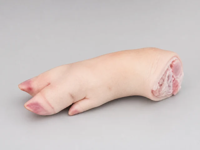 一隻帶皮生豬腳，較窄腳掌、趾端和切面小骨清楚可見