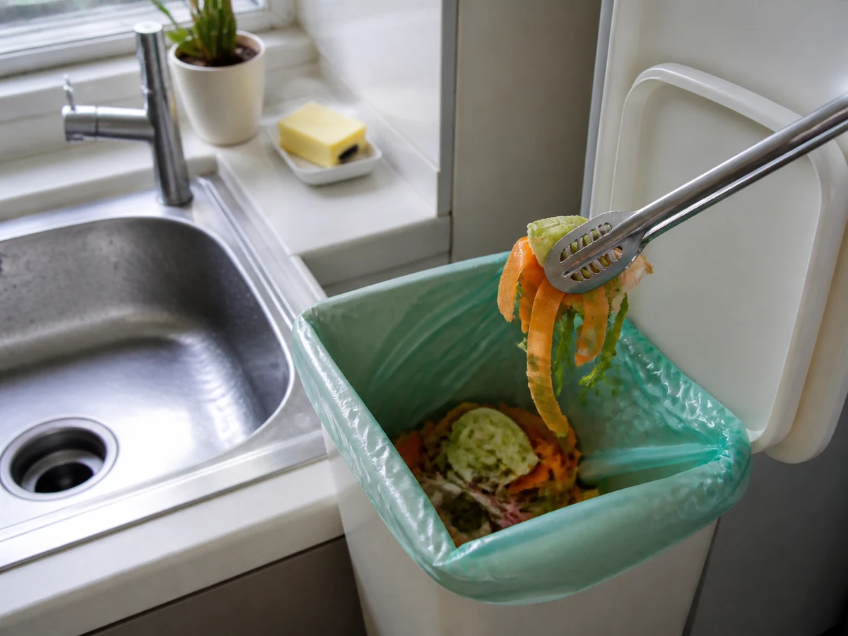 How to Clean a Kitchen Sink and Reduce Odour: Glove up and remove visible debris
