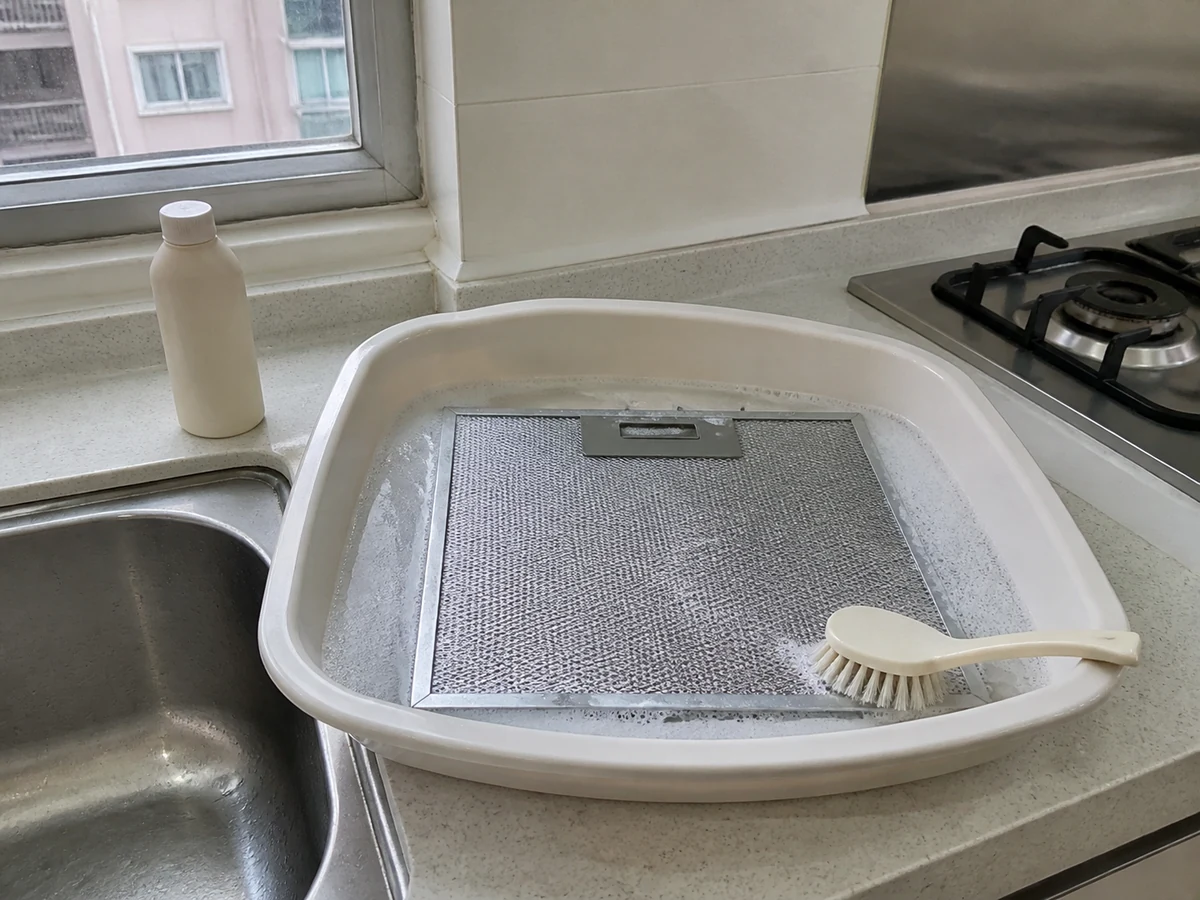 How to Clean a Range Hood Exterior and Removable Filter: Wash the approved filter