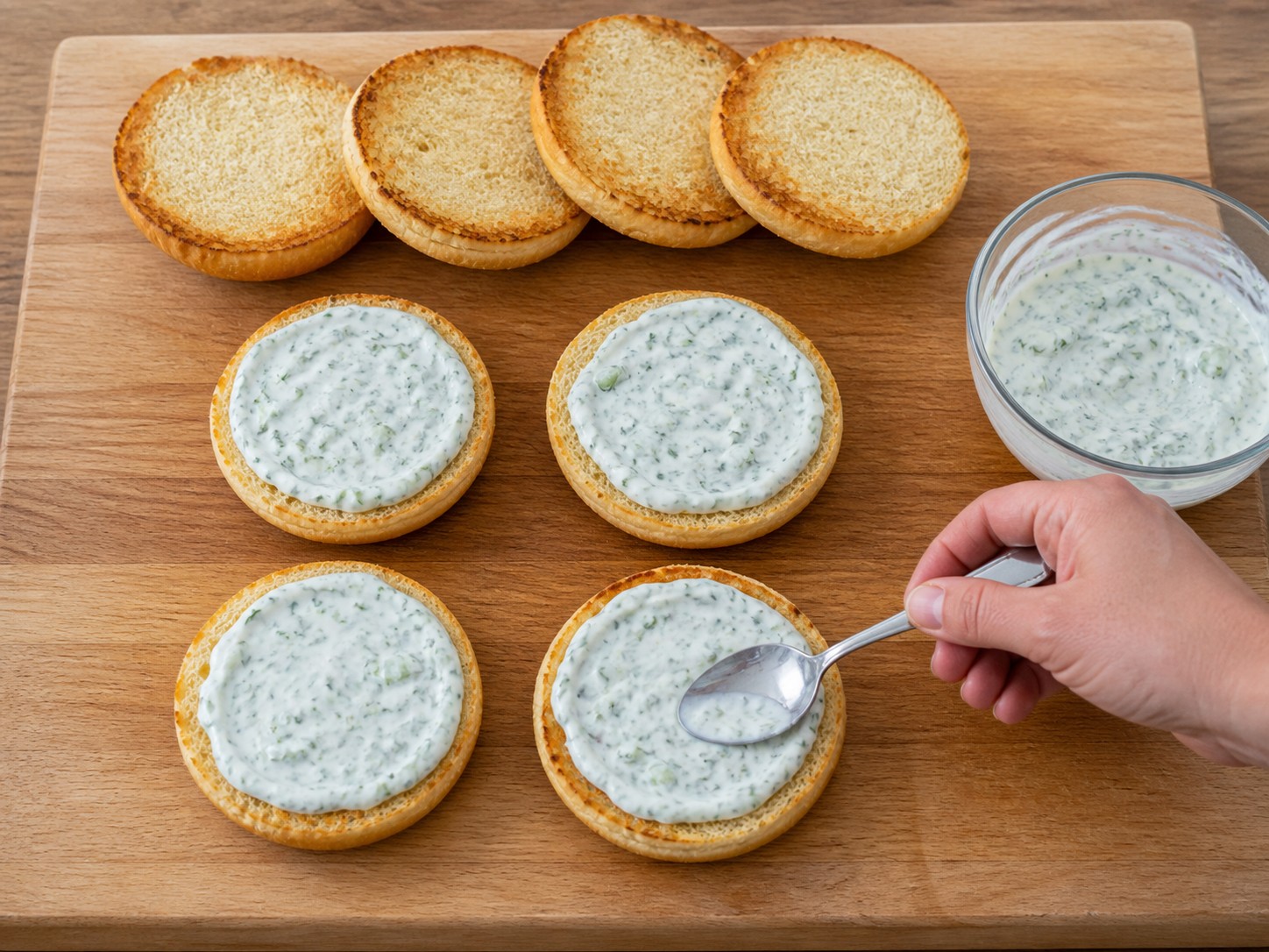 American Salmon Burgers with Cucumber Dill Sauce — Spread cucumber dill sauce on each bun