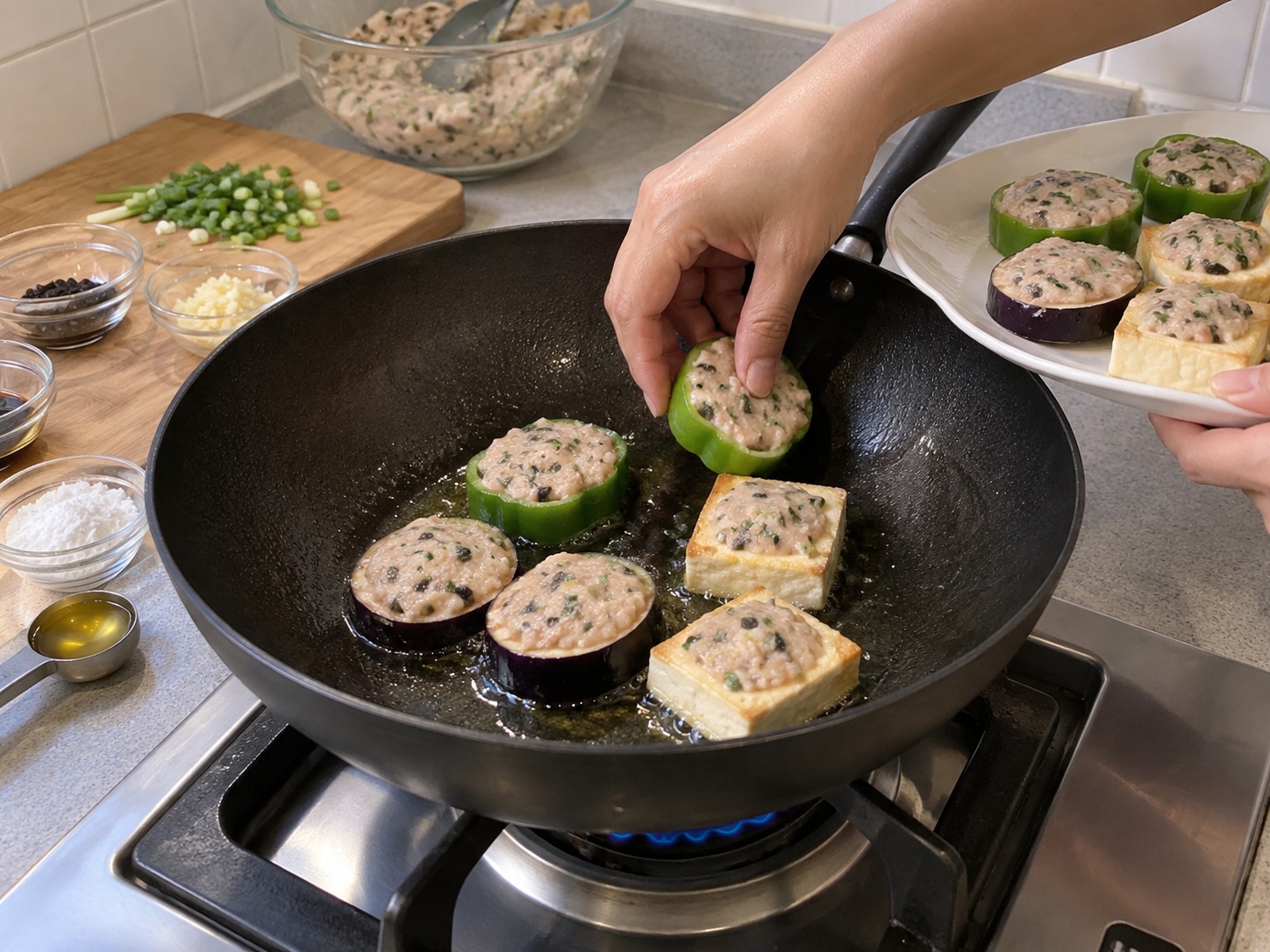 Cantonese Pan-Fried Stuffed Three Treasures — Heat two tablespoons of oil and place every piece fish-side down