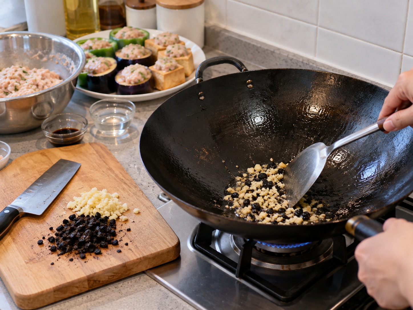 Cantonese Pan-Fried Stuffed Three Treasures — Chop black beans and garlic and fry them at the side of the wok