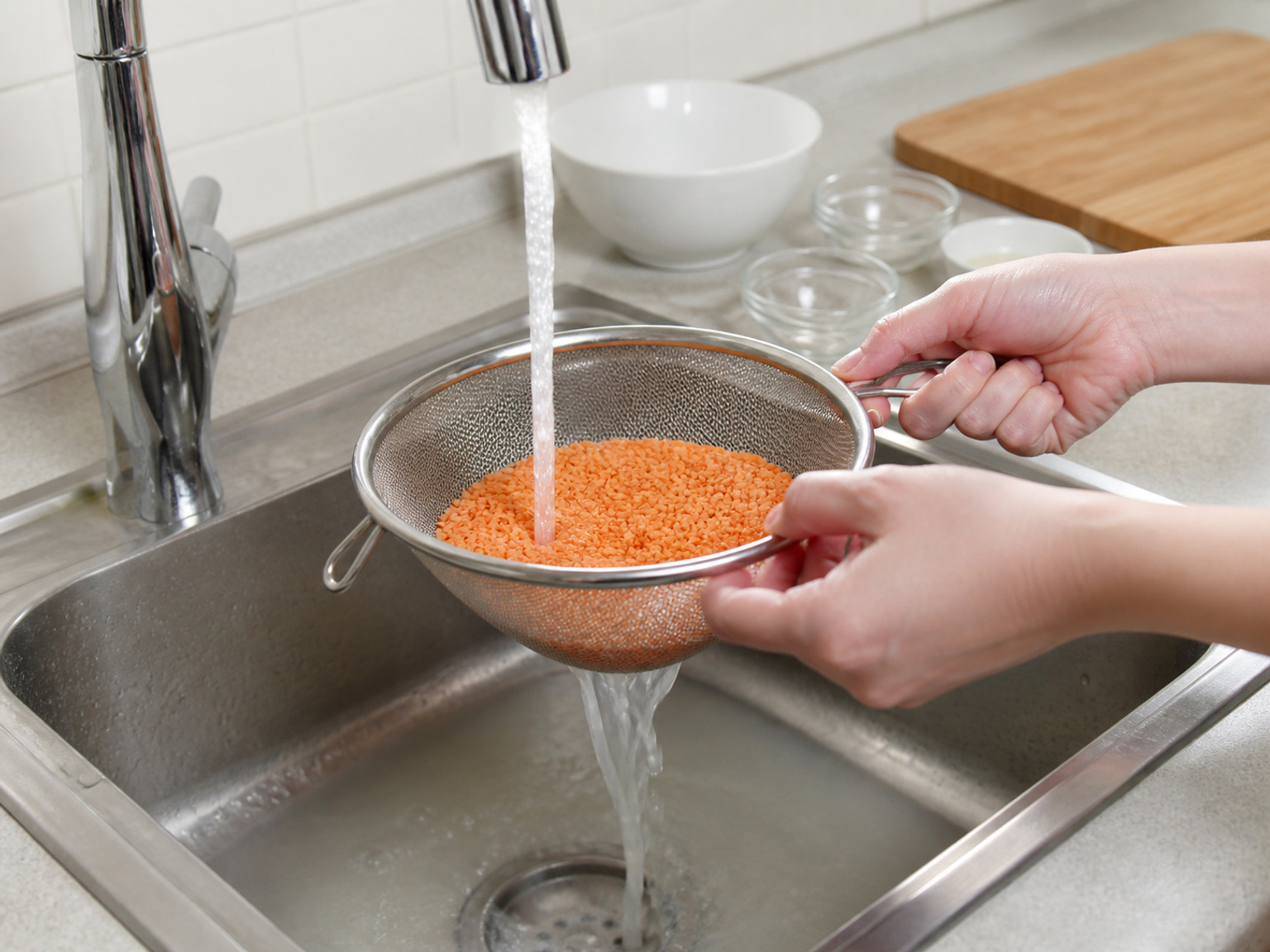 Rinse the red lentils: Rinse all 220 g red lentils in a fine sieve under cold water until the draining water is clear.