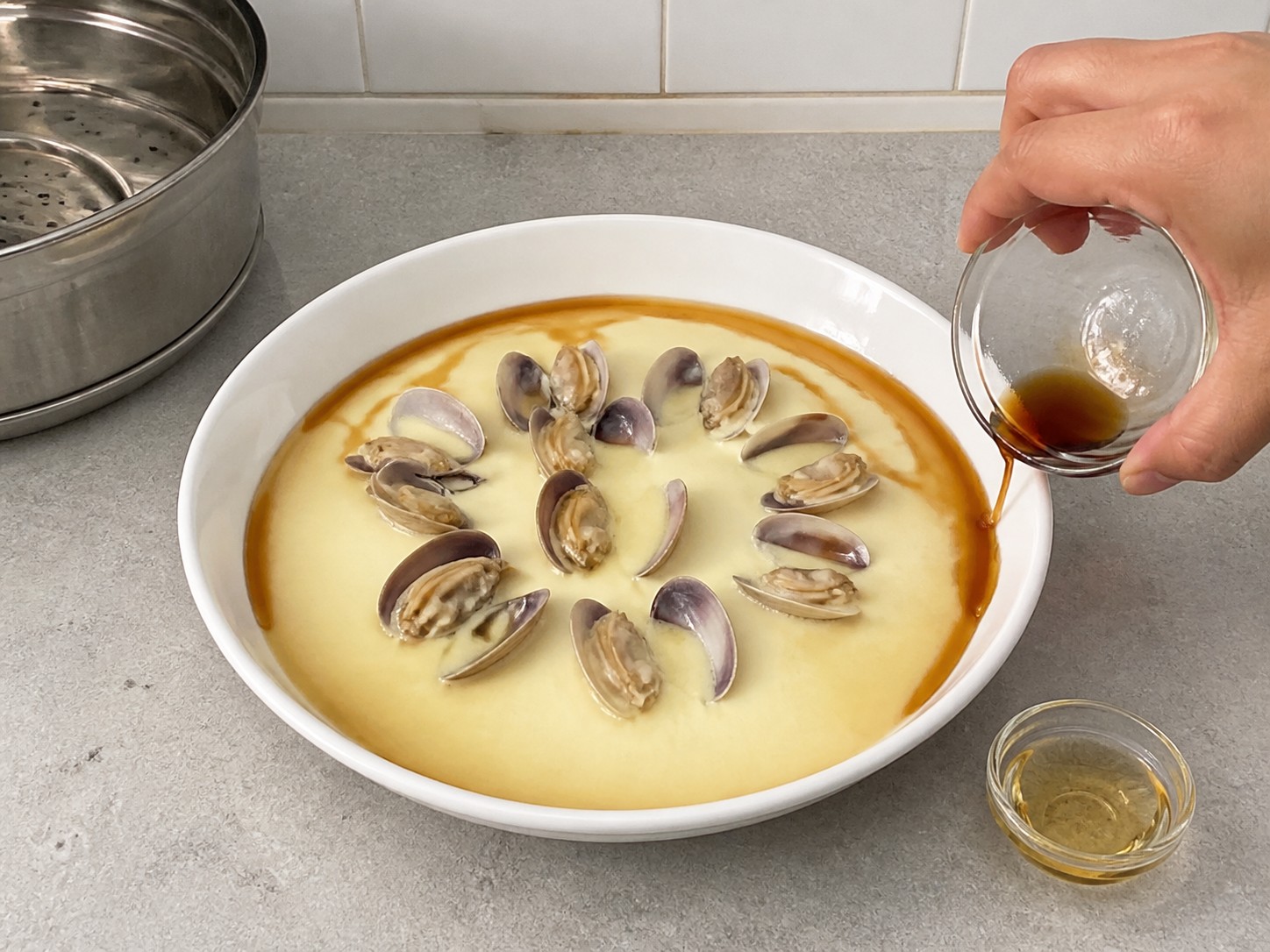 Steamed Egg Custard with Clams — step 11: Add soy and sesame oil