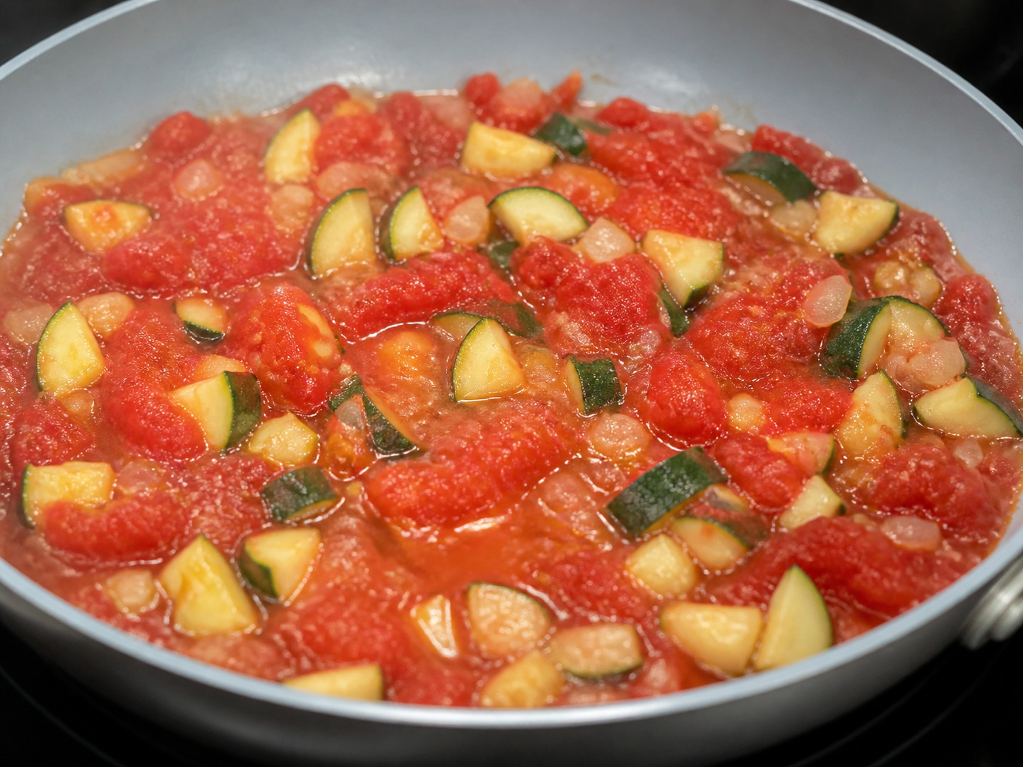 Greek Baked Tomato and Feta Orzo, step 6, Simmer the tomato base: Stir in all 400 g chopped tomatoes and simmer over medium heat for 3 minutes until bubbling evenly and slightly reduced.