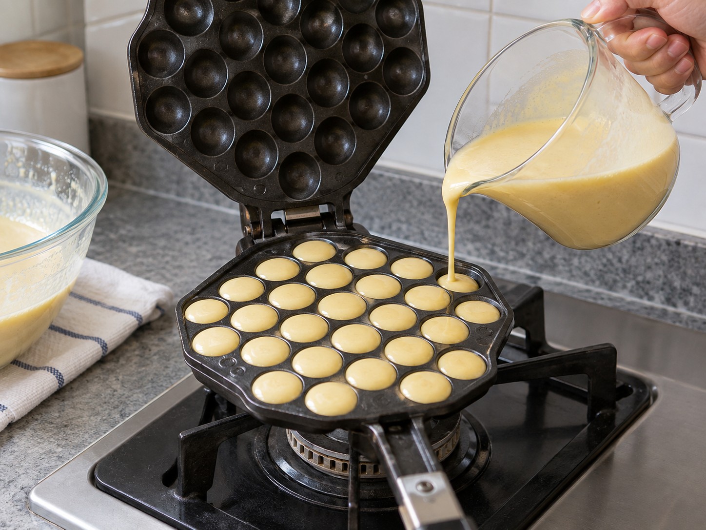 Hong Kong Egg Waffles — 8. Pour enough batter to fill each bubble mould without flooding the