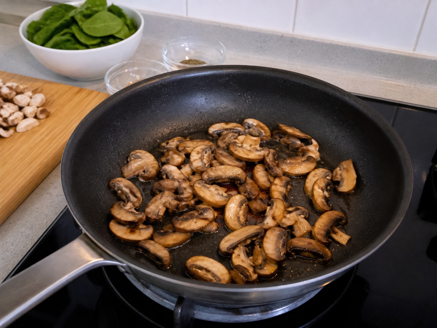 Italian Baked Polenta with Mushrooms and Spinach, step 8, Brown the mushrooms: Heat all 2 tablespoons olive oil in a wide pan over medium-high heat, add the 300 g mushrooms, and cook for 6 minutes, stirring twice, until browned and dry.