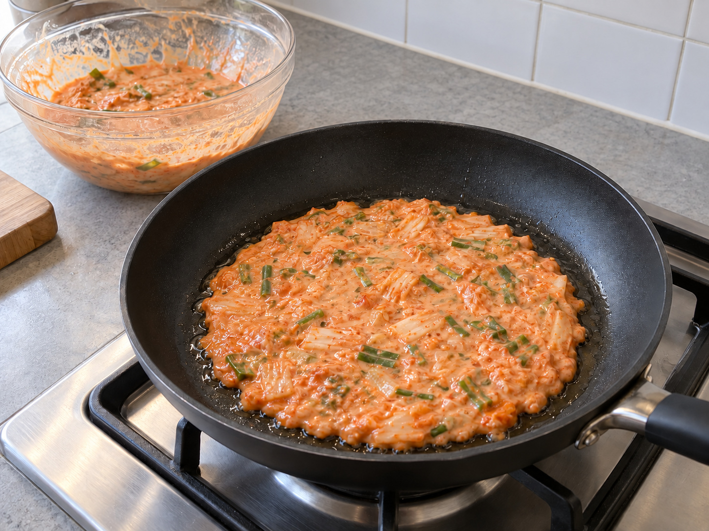 Korean Kimchi Jeon — Pour in half the batter and spread into a thin circle
