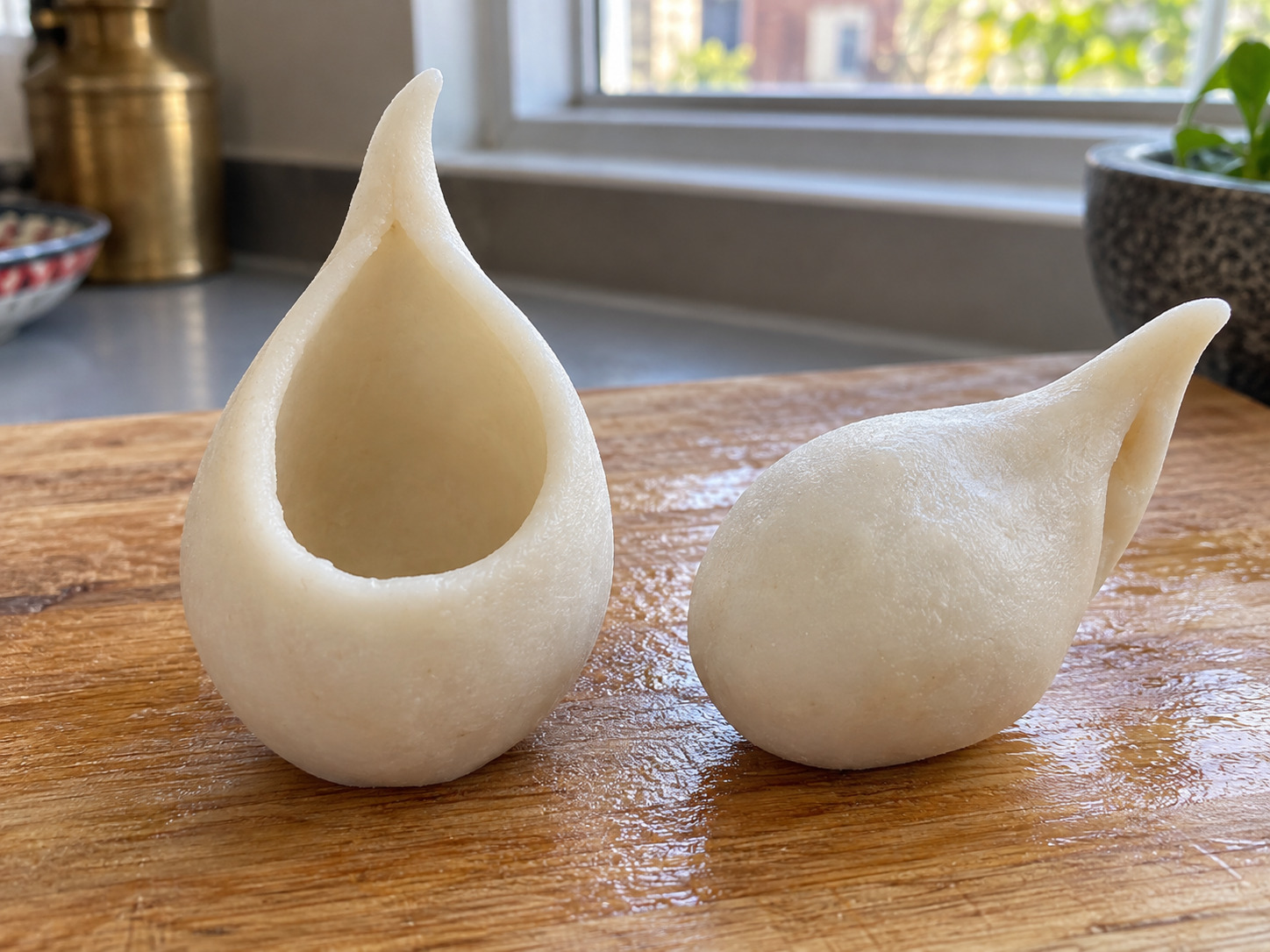 Nepali Yomari — Pinch the pocket walls into a tapered shell with a broad base and pointed top