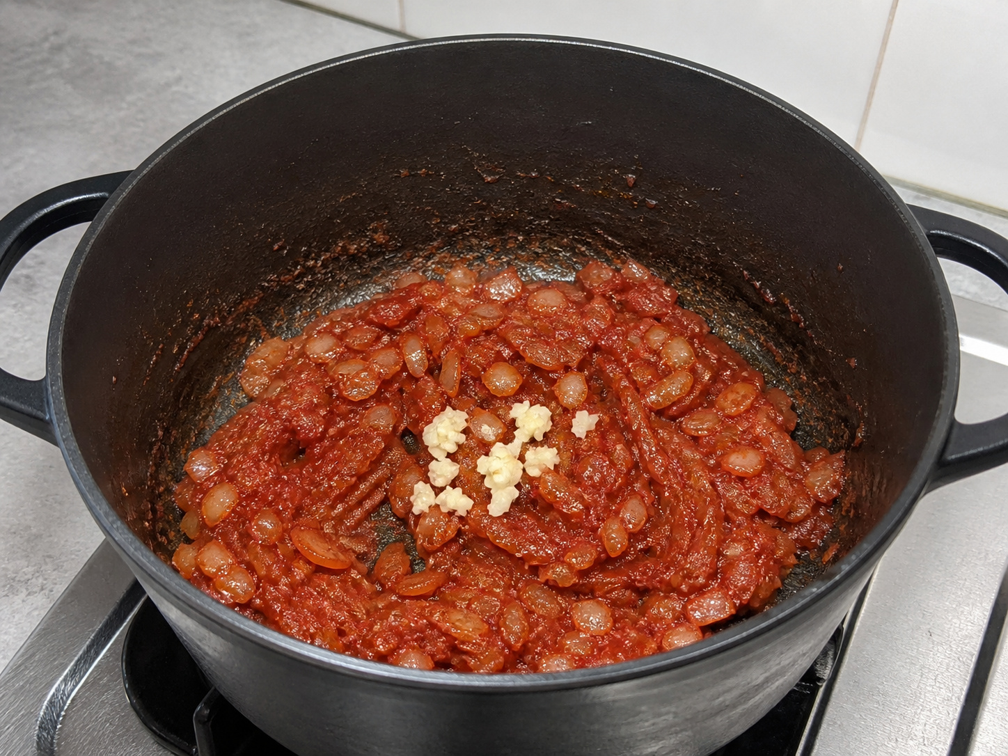 Swiss Steak with Tomato and Onions — Cook garlic and paste